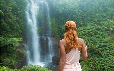 female-adventurer-looking-waterfall